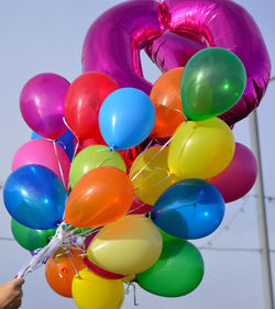 Hand holding colorful balloons