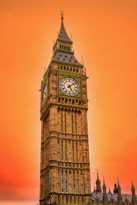 Low angle view of clock tower against sky during sunset