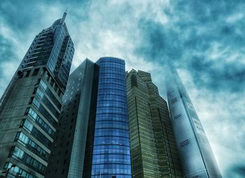 Low angle view of modern building against cloudy sky