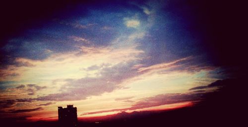 Low angle view of built structure against sky at sunset