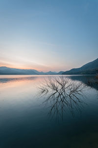 Scenic view of lake against sky during sunset