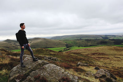 Full length of man standing on mountain against sky