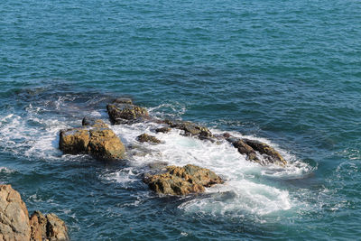 High angle view of rocks in sea