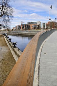 Bridge over river in city against sky