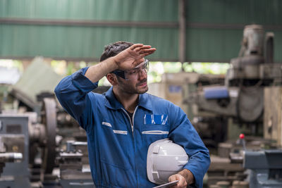 Technicians are exhausted from working on industrial machines.