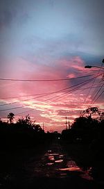 View of road against cloudy sky during sunset