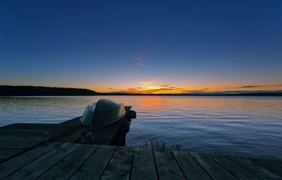 Pier on sea at sunset