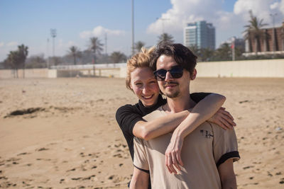 Portrait of happy young couple on beach