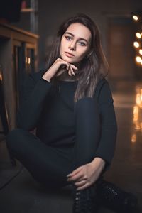 Portrait of a young woman sitting outdoors