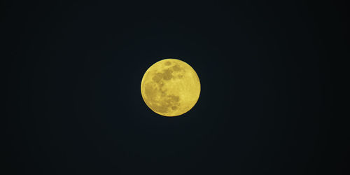 Low angle view of moon against sky at night