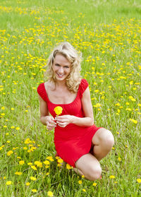 Portrait of a smiling young woman on field