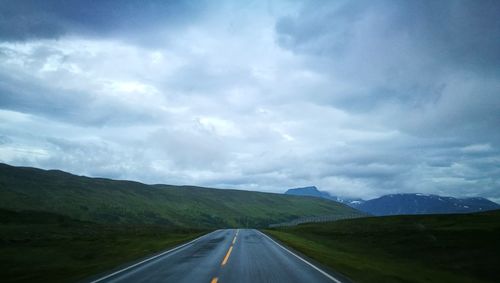 Road passing through landscape against sky