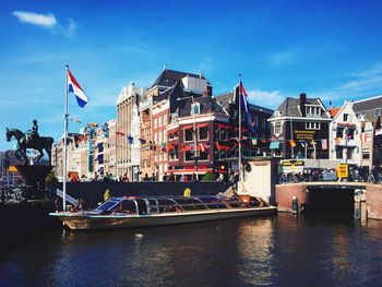 Boats in river with buildings in background
