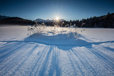 Scenic view of snow covered landscape against sky