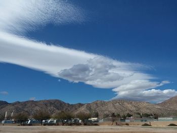 Scenic view of land against blue sky