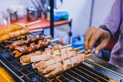 Man preparing food on barbecue grill