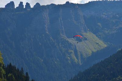 People paragliding over mountain