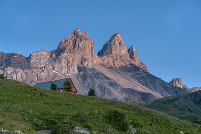 Scenic view of rocky mountains against clear blue sky