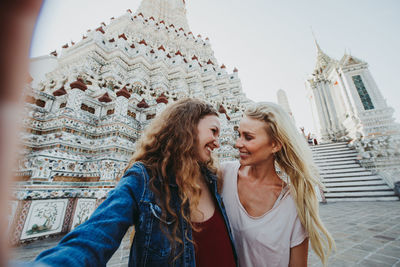 Happy women at temple in city