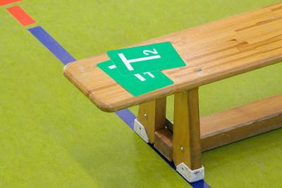 Bench at the edge of the field during a handball game. in the bench are time-out cards.