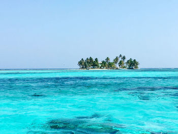 Scenic view of sea against clear blue sky