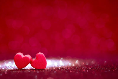 Close-up of heart shape candies against pink background