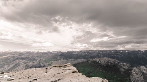 Scenic view of mountains against cloudy sky