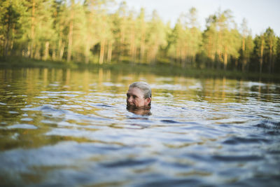 Woman swimming in lake