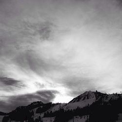 Scenic view of mountains against cloudy sky