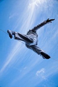 Low angle view of statue against blue sky