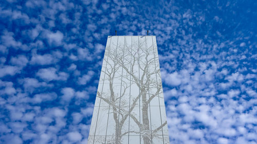 Low angle view of tower against cloudy sky