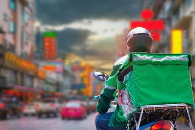 Rear view of man standing in city