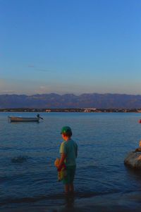 Rear view of man standing on beach