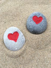 High angle view of red heart shapes rocks at beach