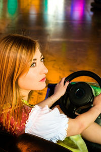 High angle view of young woman sitting in bumper car