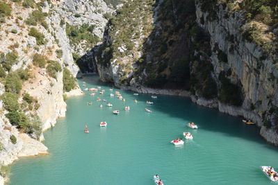 High angle view of people in sea amidst rock formation