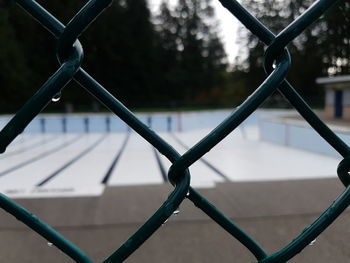 Close-up of chainlink fence against sky