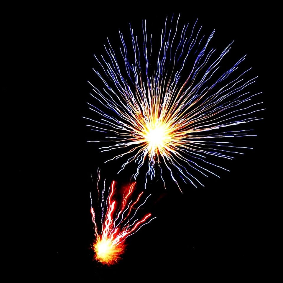 LOW ANGLE VIEW OF FIREWORKS EXPLODING