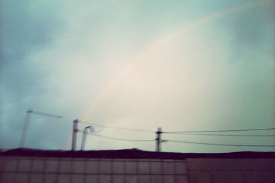 Low angle view of rainbow over mountains