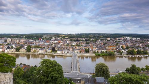 High angle view of river amidst buildings against sky