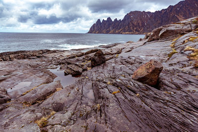 Rocks on beach against sky