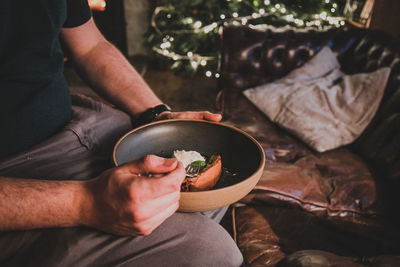 Midsection of man preparing food on table