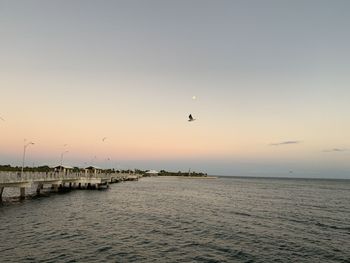 Scenic view of sea against clear sky during sunset