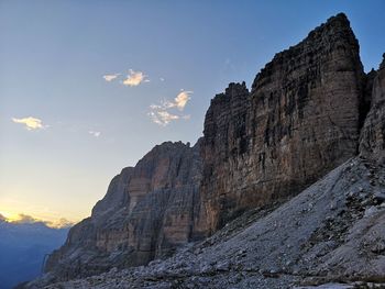 Low angle view of rocky mountains against sky