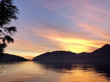 Scenic view of lake against romantic sky at sunset