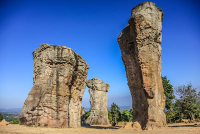 View of rock formation against clear blue sky