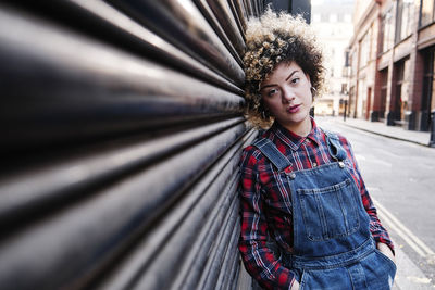 Portrait of smiling young woman standing outdoors