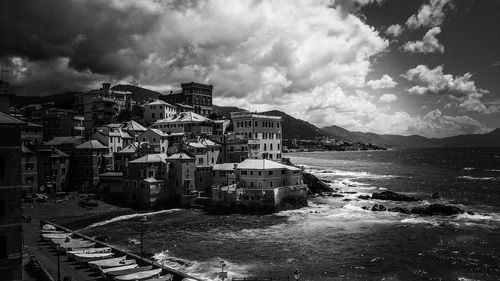 Buildings against cloudy sky