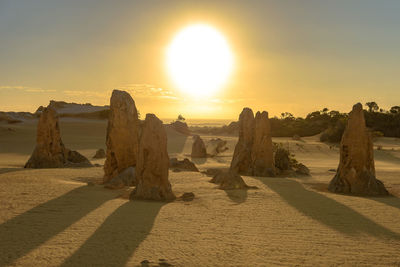 Scenic view of rocks against sky during sunset