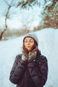 Young woman enjoying winter weather in the snow forest. cold weather. winter holidays